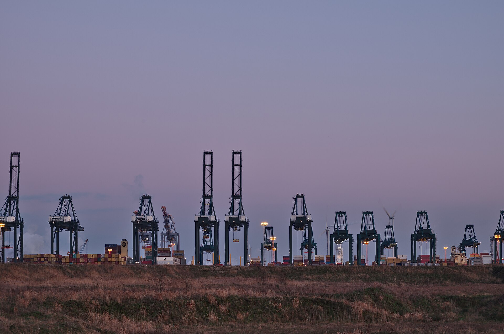 Container cranes at a terminal in the Port of Antwerp at dusk